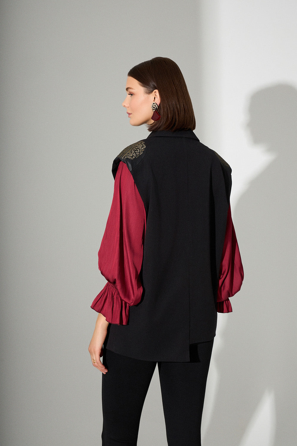 Πίσω όψη μαύρου γιλέκου με διακοσμητικούς ώμους