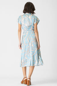Back view of a women's printed satin dress with a tie waist, short sleeves, and a stylish collar.