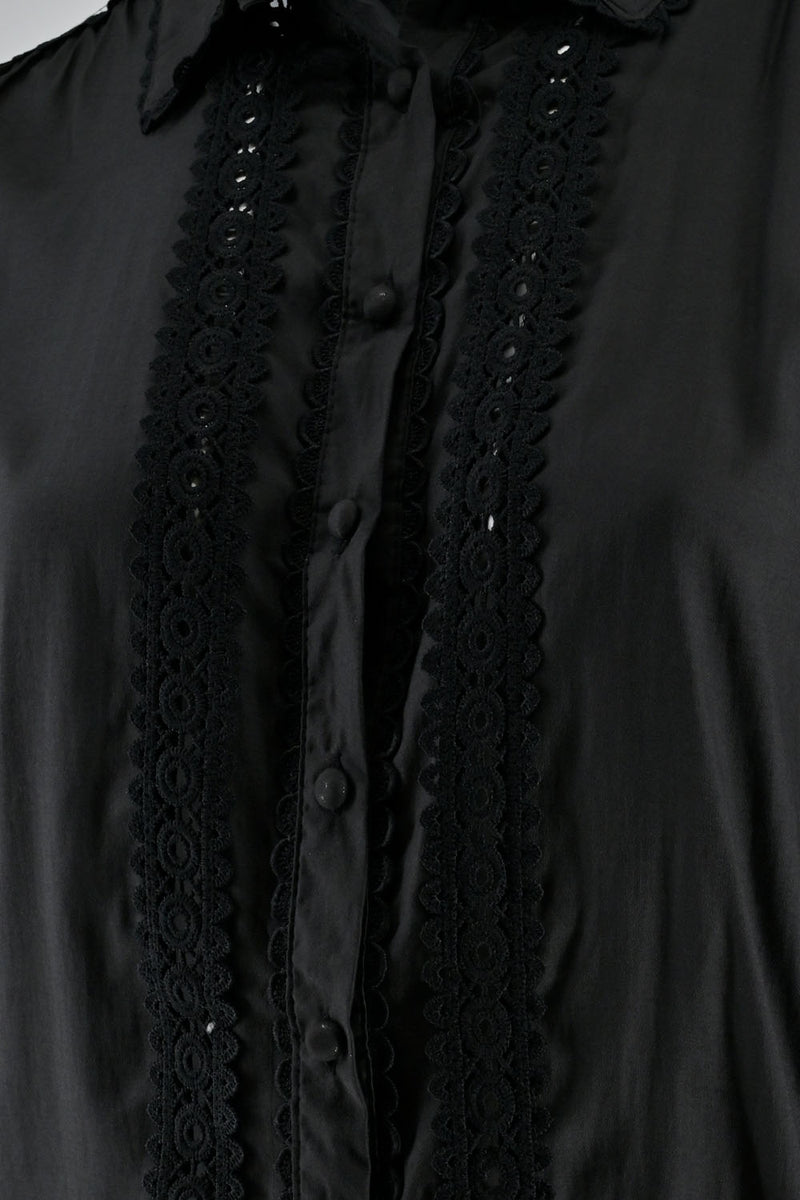 Close-up of a black shirt featuring lace details along the button placket and collar.