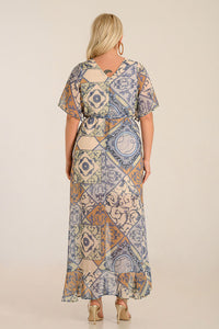 Back view of a flowing boho-chic muslin dress with intricate patterns and a belted waist, perfect for casual or formal occasions.