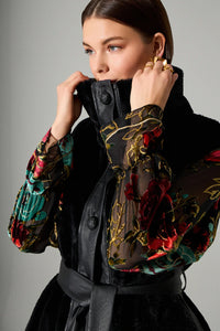 Αμάνικο μαύρο γυναικείο παλτό με ζώνη στη μέση και γιακά, φορεμένο σε μοντέλο σε studio φωτογράφιση