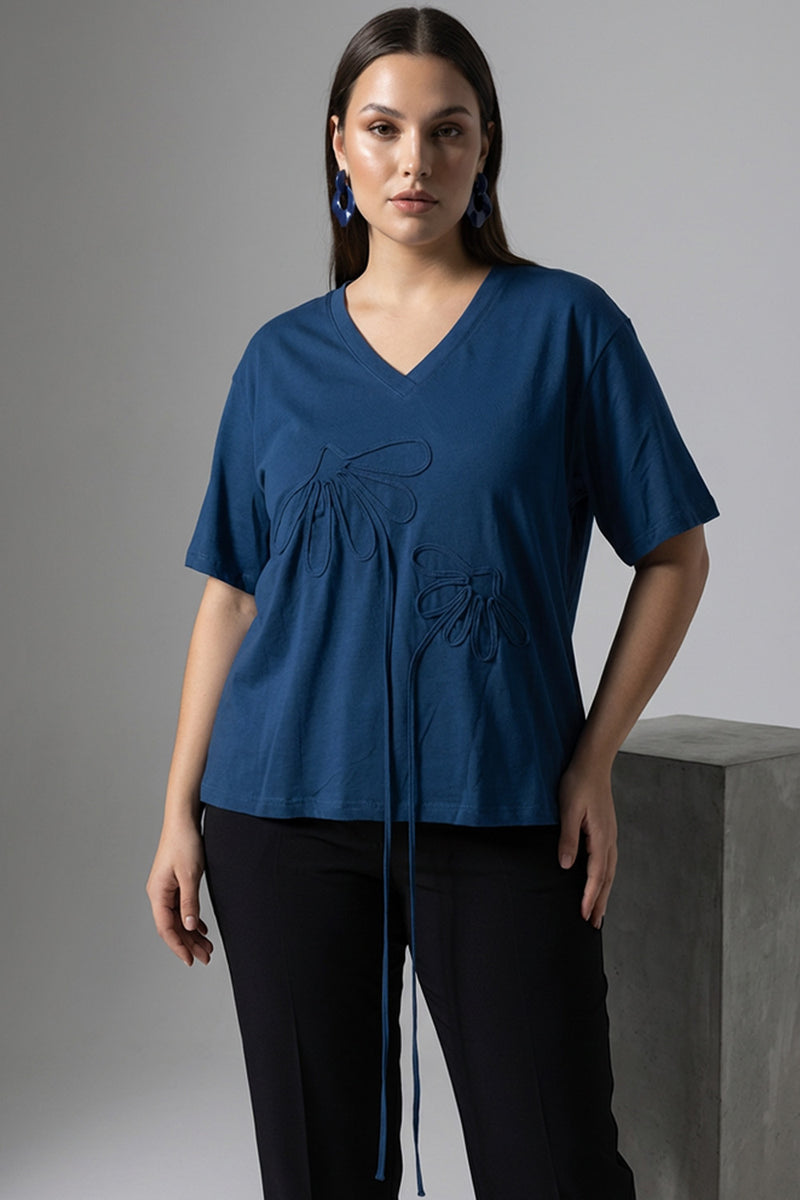 Μπλε oversized μπλούζα με V λαιμόκοψη και ανάγλυφα διακοσμητικά μοτίβα μπροστά.