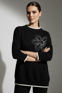 Μαύρη πλεκτή μπλούζα με ανάγλυφο λευκό λουλούδι και μανίκι 3/4 από την Ellisargi Boutique. Minimal και κομψή για καθημερινό στιλ.