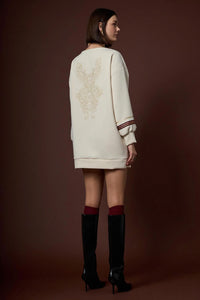 Εκρού γυναικείο μπλουζοφόρεμα με V λαιμό και μακριά μανίκια, φορεμένο σε μοντέλο σε studio φωτογράφιση