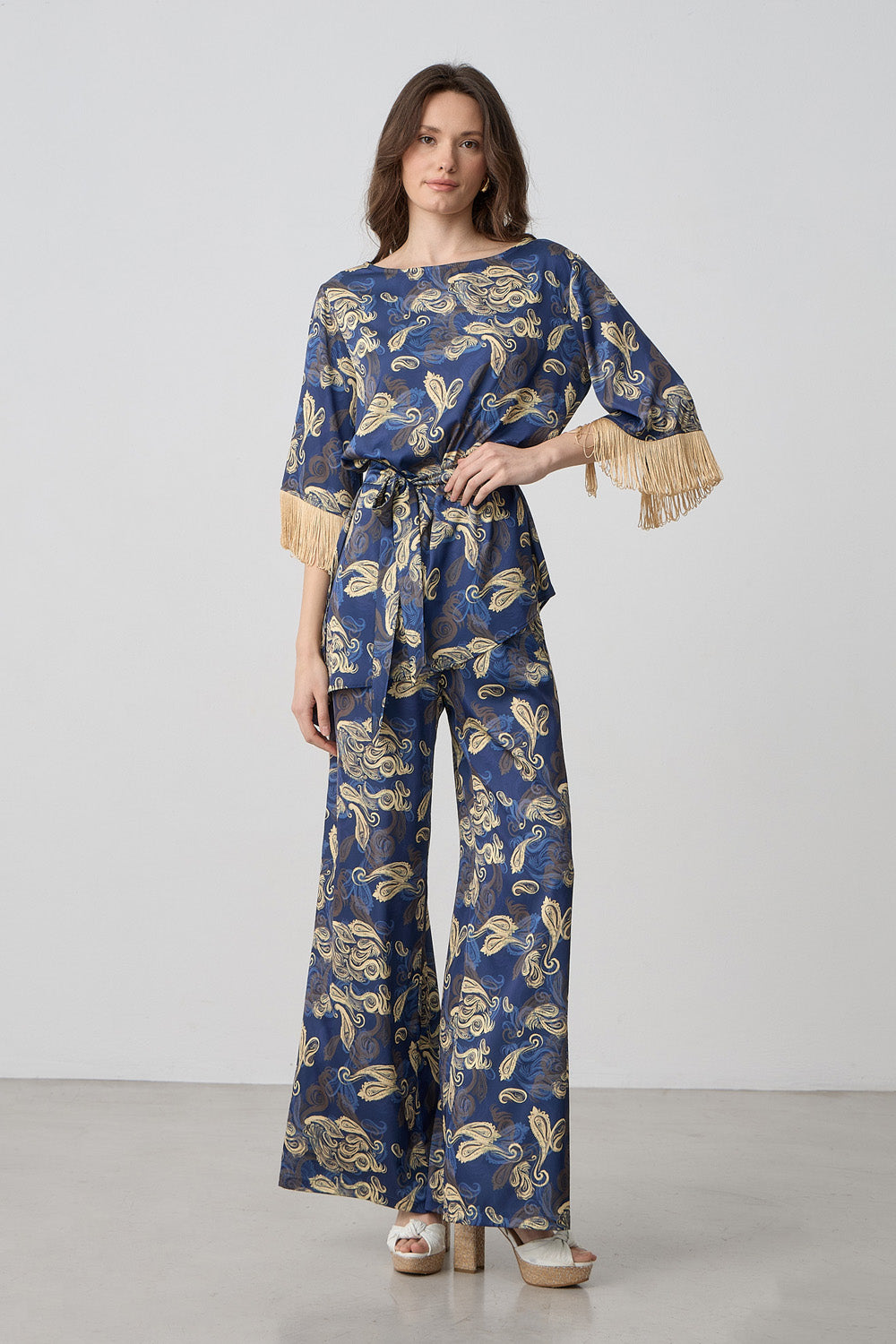 Εμπριμέ ασύμμετρη μπλούζα σε μπλε με χρυσό σχέδιο και κρόσσια στα μανίκια με δέσιμο στη μέση