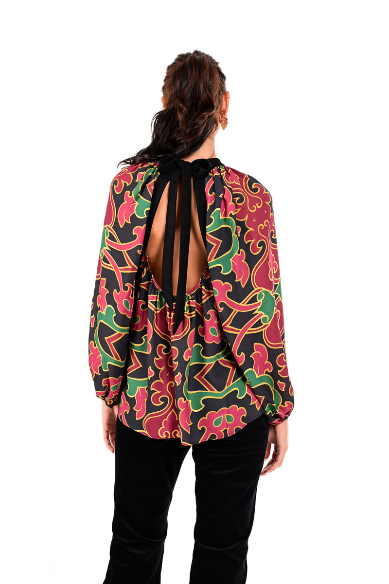 Εμπριμέ γυναικεία μπλούζα με cut-out λαιμόκοψη, μαύρες λεπτομέρειες και ανοιχτή πλάτη με δεσίματα, φορεμένη από μοντέλο.