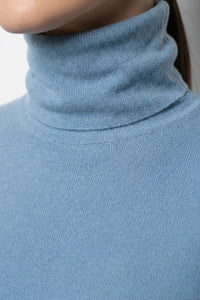 Γαλάζια πλεκτή μπλούζα ζιβάγκο με απαλή υφή σε γυναικείο μοντέλο