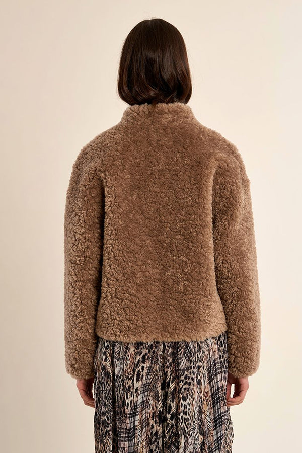 Γυναικείο κοντό teddy jacket σε καφέ απόχρωση με ψηλό γιακά, μακριά μανίκια και πλαϊνές τσέπες.