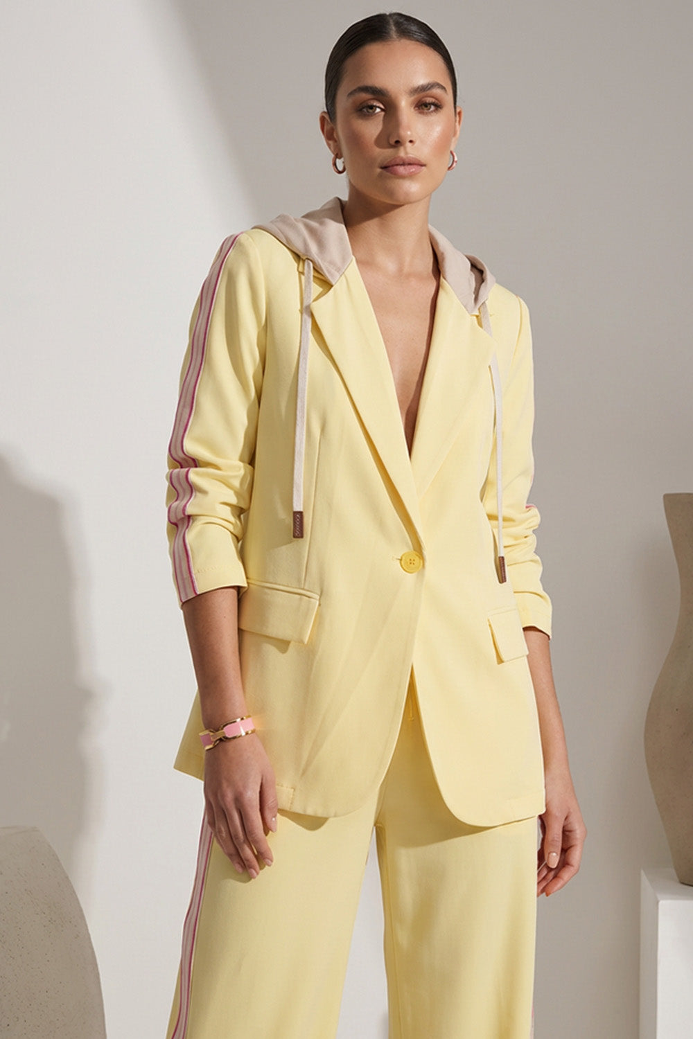 Κίτρινο γυναικείο σετ με σακάκι με κουκούλα και παντελόνι με ροζ ρίγες στο πλάι
