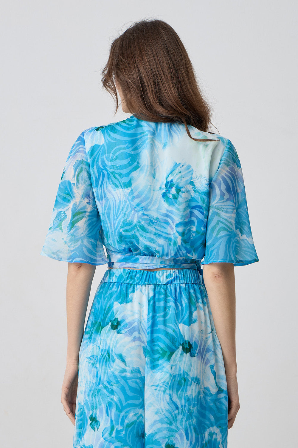 Κρουαζέ τοπ μουσελίνα εμπριμέ σε γαλάζιο και τιρκουάζ με δέσιμο στη μέση και αέρινα μανίκια