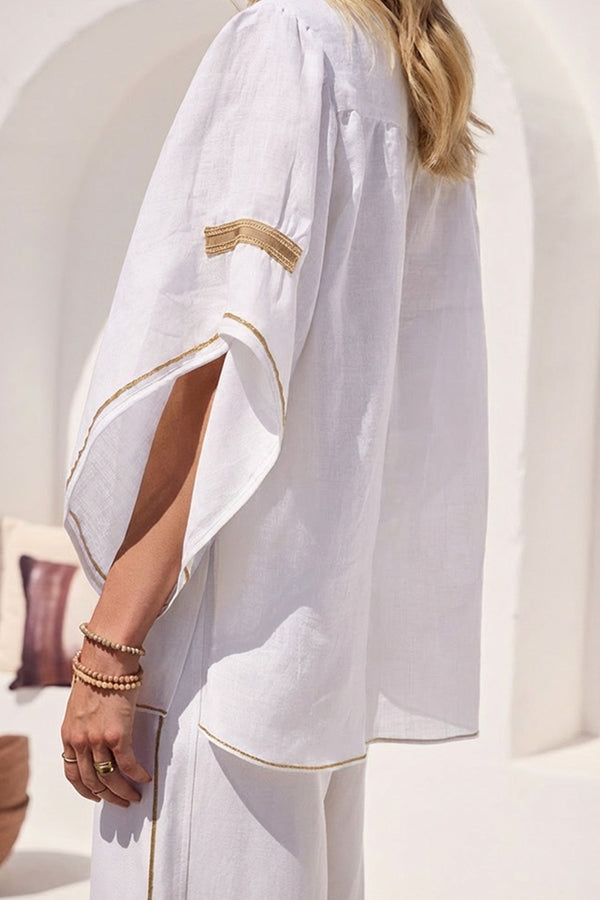 λευκή αέρινη μπλούζα με V ντεκολτέ και φαρδιά μανίκια με χρυσές λεπτομέρειες