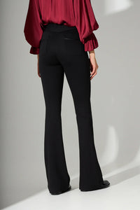 Μαύρο γυναικείο παντελόνι καμπάνα με ψηλόμεση γραμμή και πίσω τσέπες, φορεμένο σε μοντέλο σε studio περιβάλλον