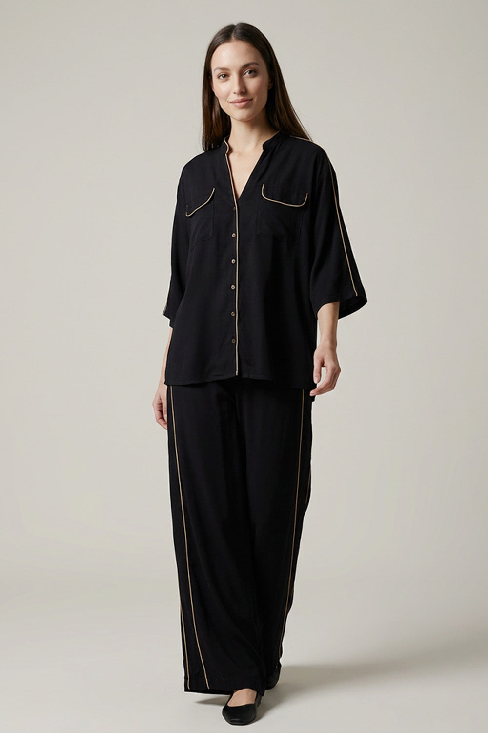 Μαύρο σετ με πουκάμισο και παντελόνα με χρυσές λεπτομέρειες.