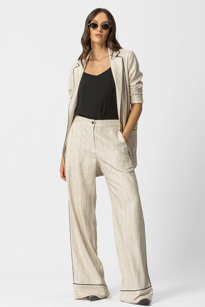 Μπεζ ριγέ γυναικεία παντελόνα σε φαρδιά γραμμή με μαύρη ρέλι στο πλάι και στο τελείωμα