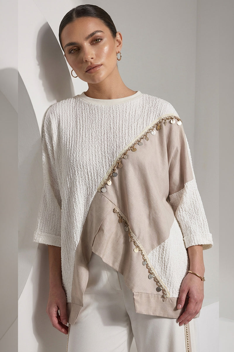 Εκρού γυναικεία μπλούζα με μπεζ ασύμμετρη λεπτομέρεια και διακοσμητική τρέσα με μεταλλικά στοιχεία