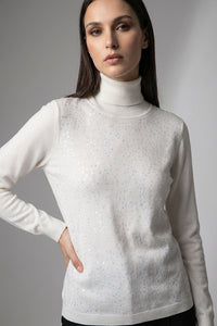 Πλεκτή μπλούζα εκρού ζιβάγκο με διακριτική παγιέτα στο μπροστινό μέρος και μακριά μανίκια, σε κομψή άνετη γραμμή.