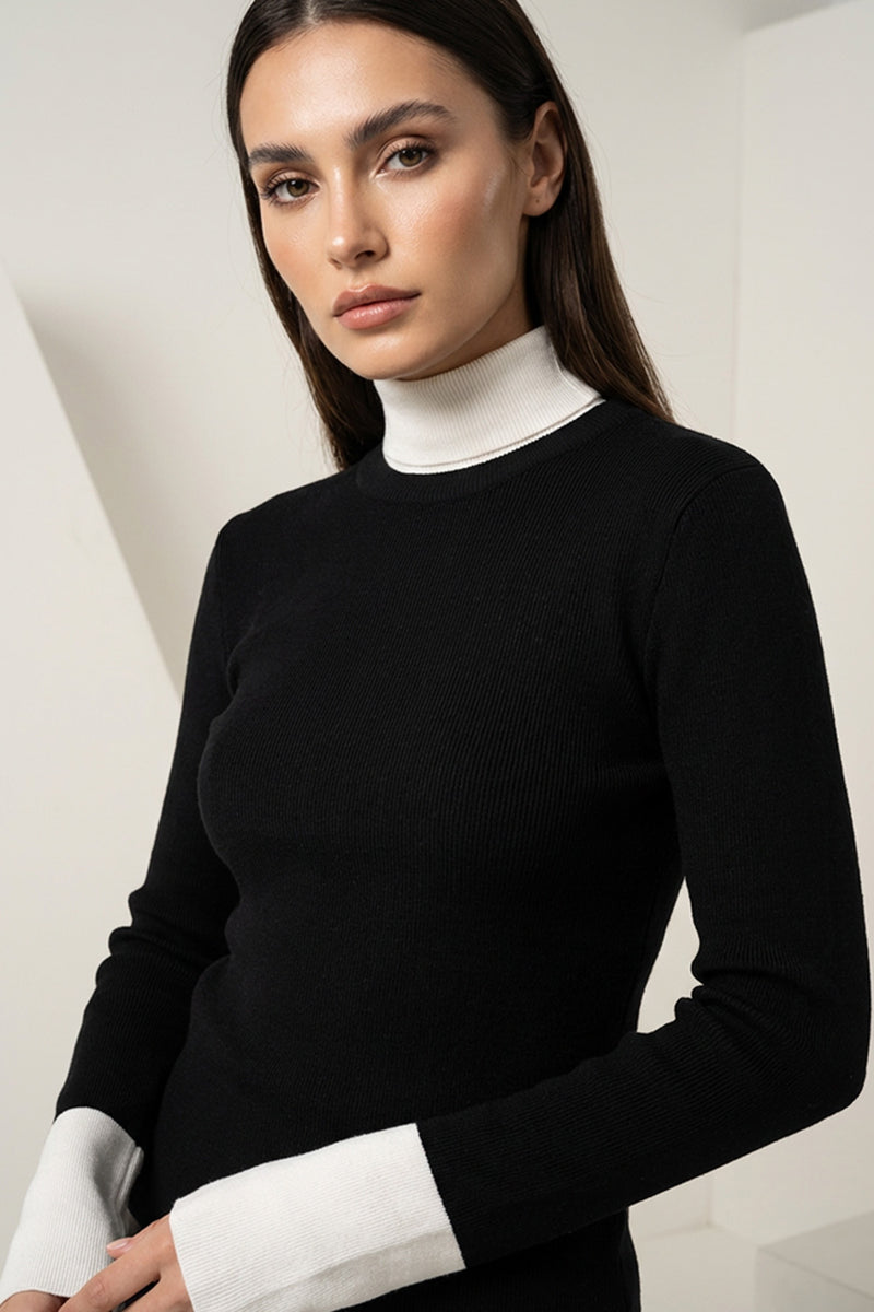 Πλεκτή μαύρη μπλούζα με λευκό γιακά και μανσέτες σε εφαρμοστή γραμμή, φορεμένη από μοντέλο.