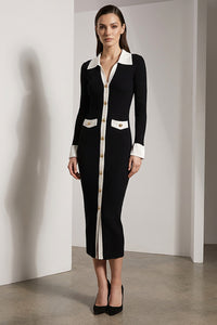 Μαύρο πλεκτό φόρεμα με λευκές λεπτομέρειες και χρυσά κουμπιά, φορεμένο από μοντέλο studio.